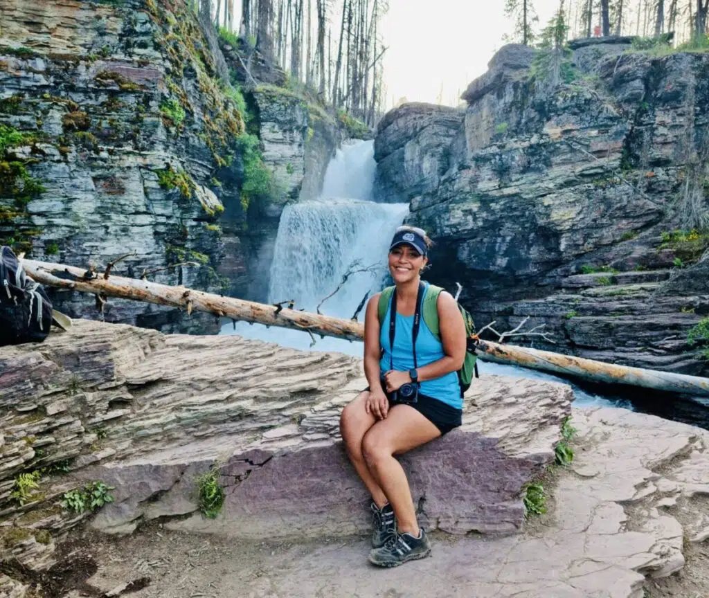 Alexandrea Sumuel Groves in front of St. Mary Falls at Glacier National Park in Montana.