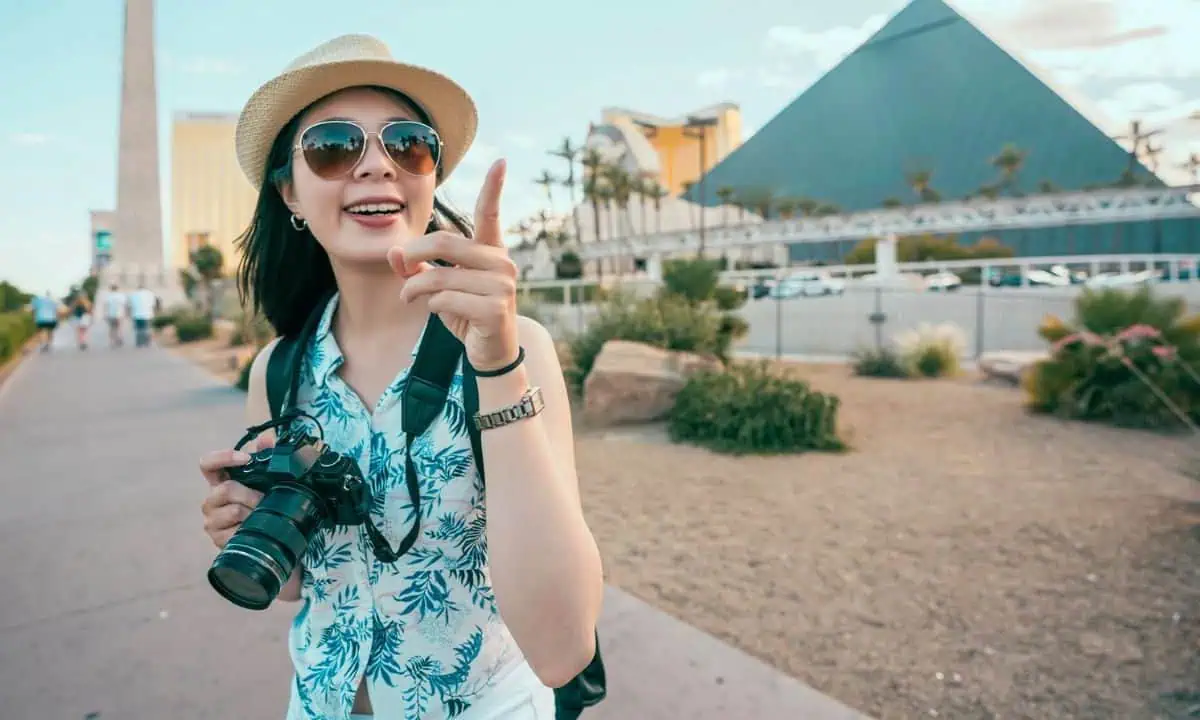 Woman making photo smiling at pyramids, Las Vegas