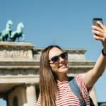 Woman making selfie in front of Branderburger Tor, Berlin, Germany