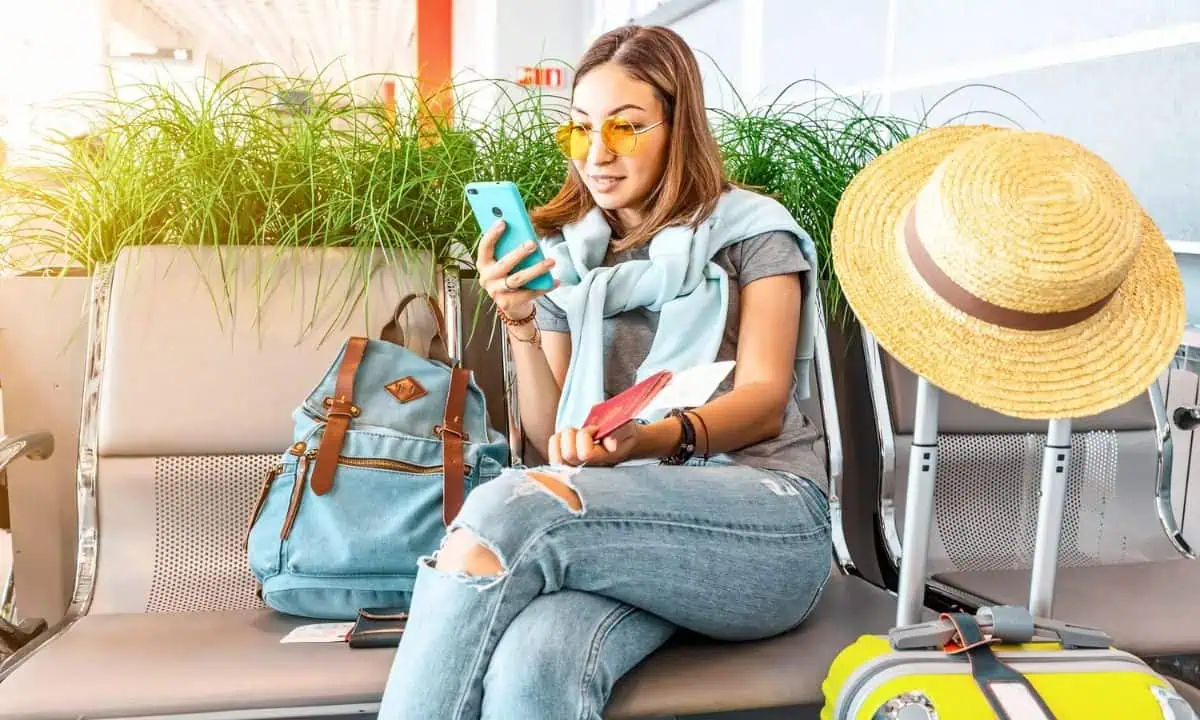 Woman waiting in airport on phone
