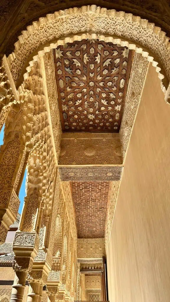 intricately carved stucco arches in the Court of the Lions at the Nasrid Palaces