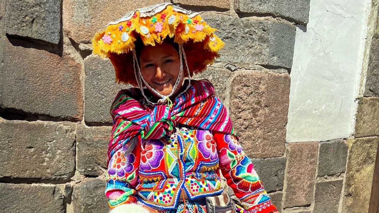 Peruvian woman and baby alpaca in Cusco